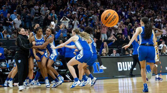 Duke Blue Devils guard Ashlon Jackson is surrounded by teammates after her game-winning basket over the Louisiana State University Tigers during the NCAA Women’s Basketball Tournament Sweet 16 game at Golden 1 Center in Sacramento on Friday. Duke Blue Devils guard Ashlon Jackson is surrounded by teammates after her game-winning basket over the Louisiana State University Tigers during the NCAA Women’s Basketball Tournament Sweet 16 game at Golden 1 Center in Sacramento on Friday.